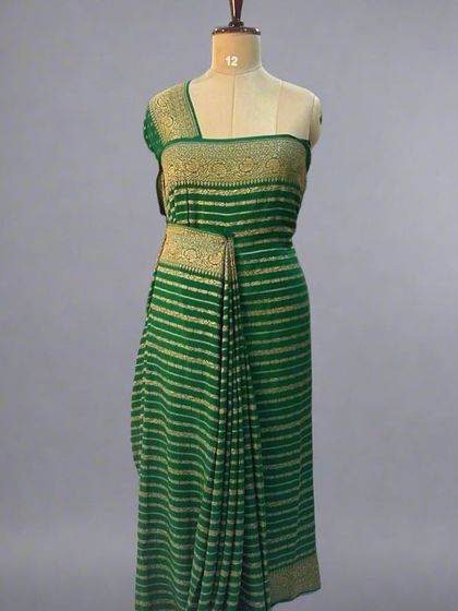 A mannequin draped in a green pure Banaras crepe saree with stripes.