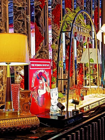 A close-up of the detailed decor on one of our bars, including vintage-style lamps, tiki glasses, and retro artwork.
