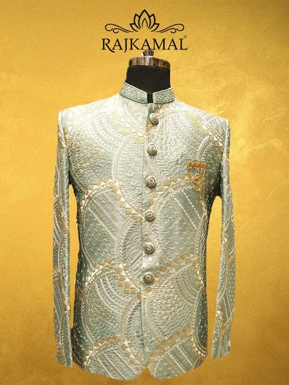 A full front view of the pastel green Jodhpuri, showing the detailed button placket and the rich, textured pattern of the embroidery.
