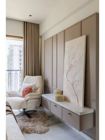 A view of the seating area in the bedroom. The comfortable armchair, soft rug, and custom console with 3D artwork create a perfect corner for relaxation and quiet contemplation.