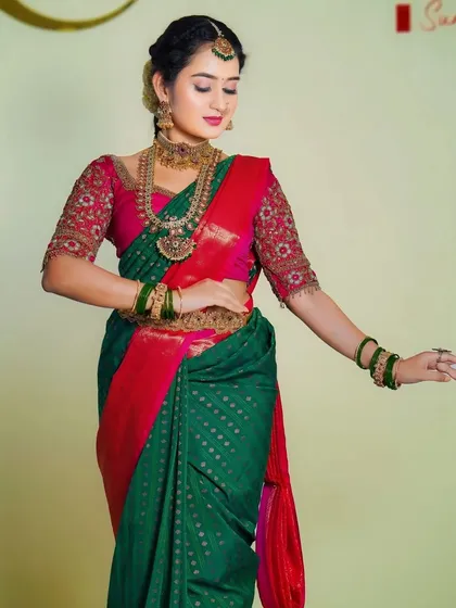 This bride is wearing a classic temple jewellery set with green and pink stones, perfectly matching her saree.