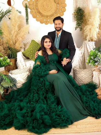 This portrait showcases a stunning emerald green gown in my boho-chic studio setup. The rich color and textures create a luxurious and earthy feel for this maternity session.