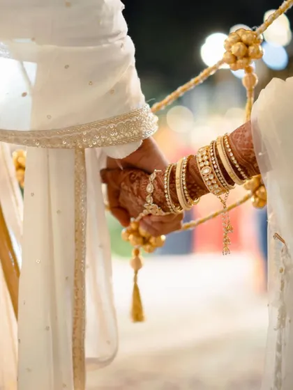 The holding of hands during the pheras, a simple act that symbolizes their promise to walk together through life.