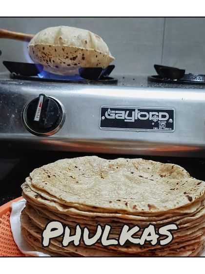 Soft, fluffy phulkas being made fresh on the stove. I ensure every part of your meal is homemade with care.