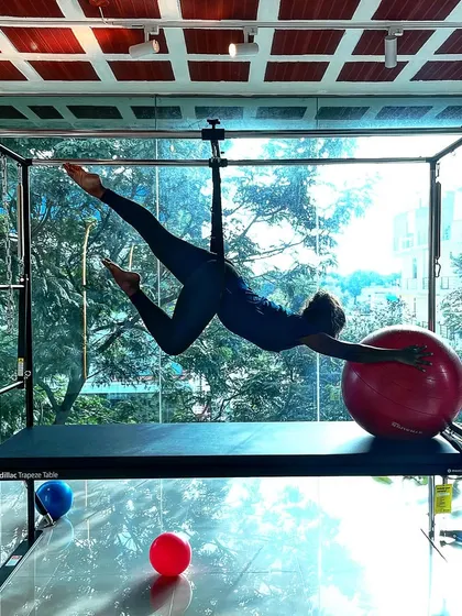 Bring out your inner strength. This flying pose on the Cadillac, using the stability ball, is a joyful expression of movement.