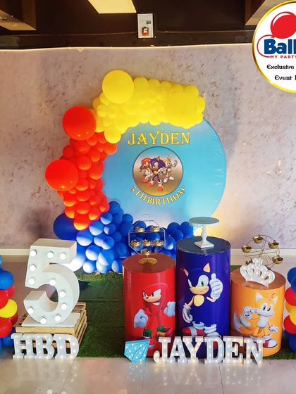 A speedy Sonic the Hedgehog-themed fifth birthday. The setup features a character backdrop, themed plinths, and a large light-up number '5'.