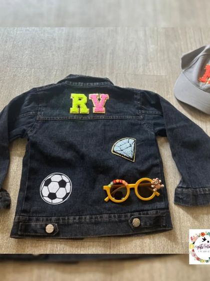 Another custom denim jacket for a child, this one with a soccer ball and diamond patch. The name on the back and the initial on the cap are fully customizable.