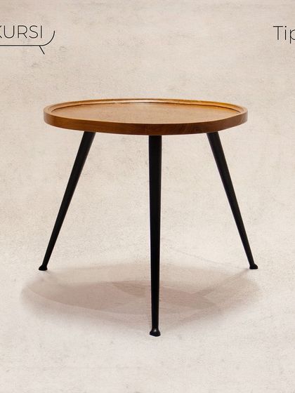 The 'Tipoy' side table. A simple yet elegant design with a solid teak top and sleek, tapered metal legs. It's a versatile piece for any corner.