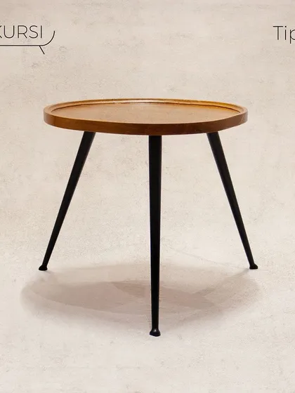 The 'Tipoy' side table. A simple yet elegant design with a solid teak top and sleek, tapered metal legs. It's a versatile piece for any corner.