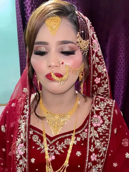 Magic in her eyes. This close-up shows the detailed eye makeup and the traditional nath, key elements of a classic Muslim bridal look.