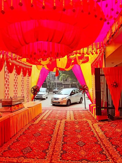 The entrance of the housewarming tent, showing the buffet setup and the welcoming passage for guests.