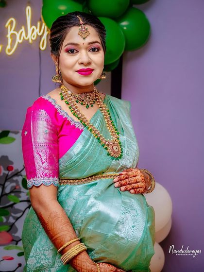 A lovely, smiling portrait of the guest of honor. Her traditional jewelry and attire are beautifully captured in this shot.