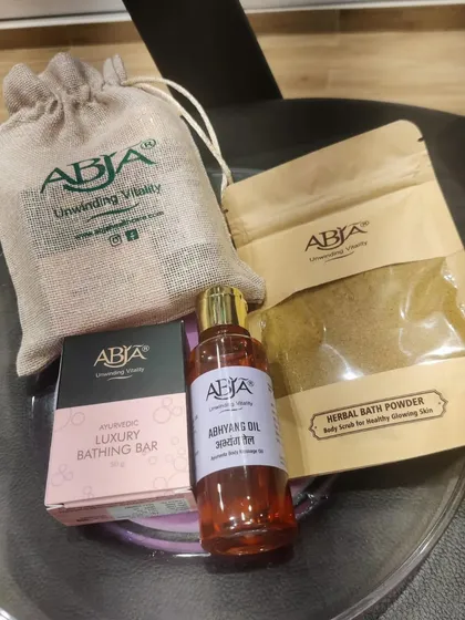 My Abhyanga gift kit, which includes a body massage oil, herbal bath powder, and a luxury bathing bar.