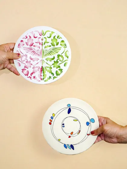 A shot of two hands holding up different artisanal plates. This is a simple but effective way to showcase the designs and add a human touch.