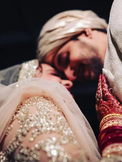 A tender and emotional moment between the bride and groom. This close-up shot from a Nikkah ceremony focuses on the deep affection and connection that words cannot express.