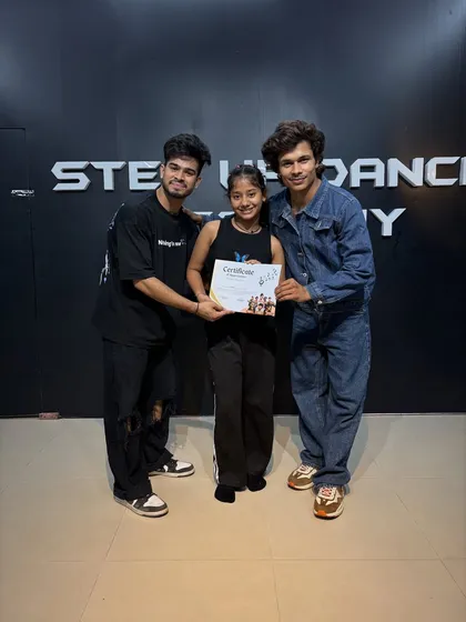 A proud moment for this student, holding her certificate of completion.