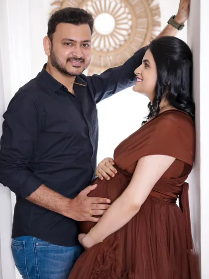 A bright and happy couple's portrait. This shot captures the natural light and easy chemistry between the parents-to-be in our airy studio setting.