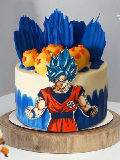 A powerful Dragon Ball Z cake for a Super Saiyan fan. This design features Goku in his blue form, ready for battle, with edible Dragon Balls in the background.