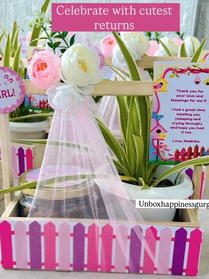 "Celebrate with cutest returns." This image showcases the charming combination of a plant and cookies in a decorated basket.