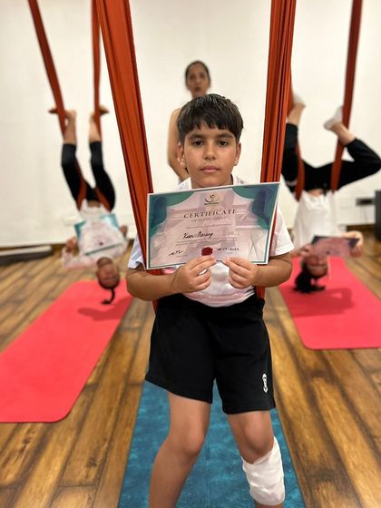 A young yogi proudly displays his completion certificate from our summer workshop. It's a pleasure to teach the future generation.