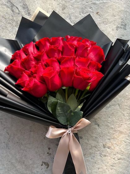 A full view of the classic red rose bouquet, tied with a simple, elegant ribbon. This is a timeless gesture of love and admiration that never goes out of style.