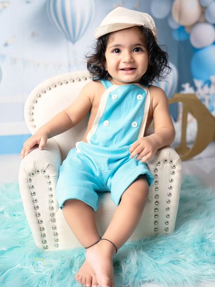 A sweet and simple portrait for a first birthday. This little guy's charming smile is the centerpiece of this lovely blue-themed studio session.