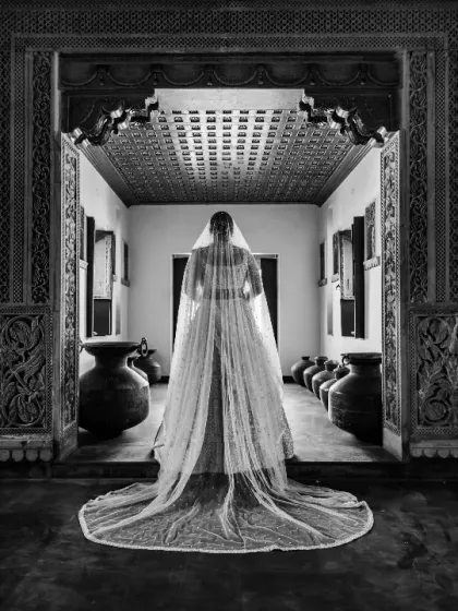 A bride's portrait should be as timeless as she is. Here, we captured Vedika framed by the intricate architecture, her veil catching the light. It’s a moment of regal elegance, showcasing not just the outfit, but the grace of the woman wearing it.