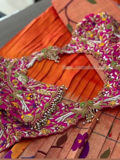 The back of the pink blouse, with delicate tassels.