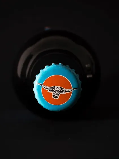 A top-down shot of a Flying Buffalo beer cap. This kind of detailed branding shot is great for adding visual interest to a website or social media feed.