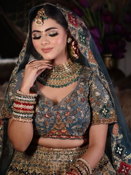 A close-up portrait focusing on the soft glam makeup and the intricate details of the jewelry.