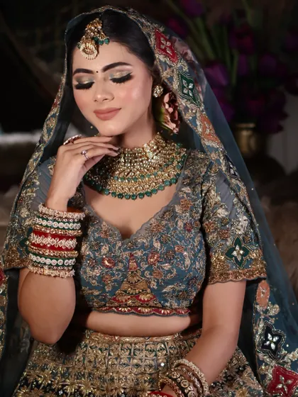 A close-up portrait focusing on the soft glam makeup and the intricate details of the jewelry.