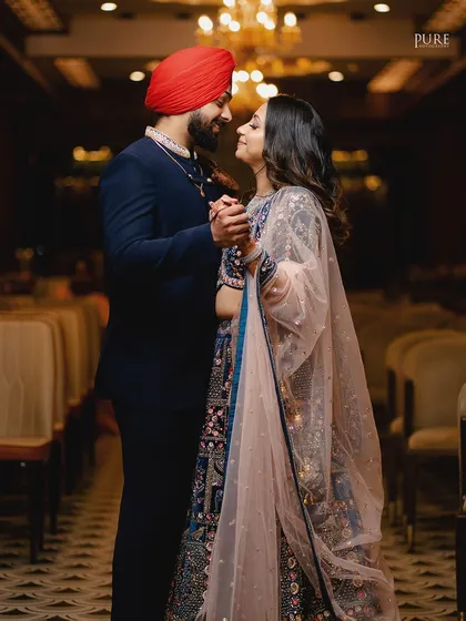 A romantic dance between the newly engaged couple. The soft lighting and their happy expressions make this a beautiful, candid moment.