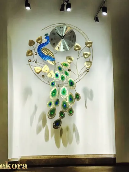 This handcrafted metal peacock clock is one of our signature pieces, designed to be a stunning work of art for your living room or entryway wall.