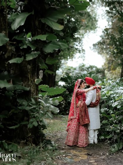 A romantic portrait in a lush, green forest. The natural surroundings create a beautiful, intimate setting for the couple's love story.