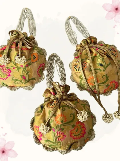 I love playing with patterns and textures. These potlis feature a lovely floral brocade fabric and are finished with a pearl-studded handle, combining traditional materials with a touch of modern elegance.