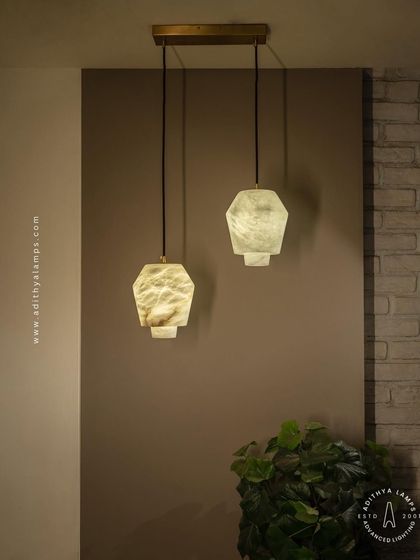 A pair of our hexagonal marble pendants, showcasing how they can be used in multiples to create a balanced and stylish lighting arrangement over a kitchen island or bar.