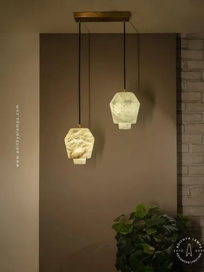 A pair of our hexagonal marble pendants, showcasing how they can be used in multiples to create a balanced and stylish lighting arrangement over a kitchen island or bar.