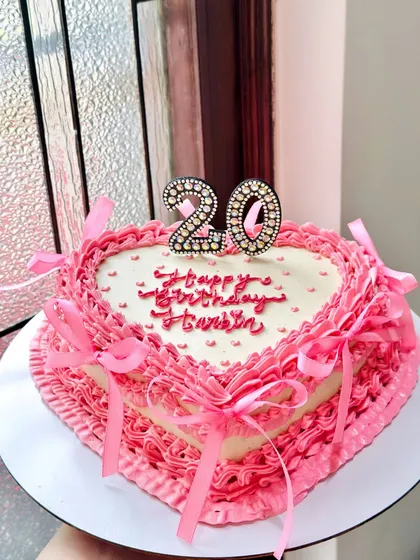 Our vintage heart cakes are one of our most requested styles. This beauty, for a 20th birthday, features layers of delicate pink ruffles, intricate piping, and pretty satin bows. It’s a classic chocolate truffle cake that tastes as dreamy as it looks.