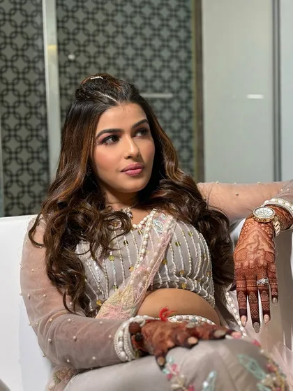 A relaxed, confident pose. The makeup is kept fresh and radiant, allowing the unique outfit and the bride's personality to shine.