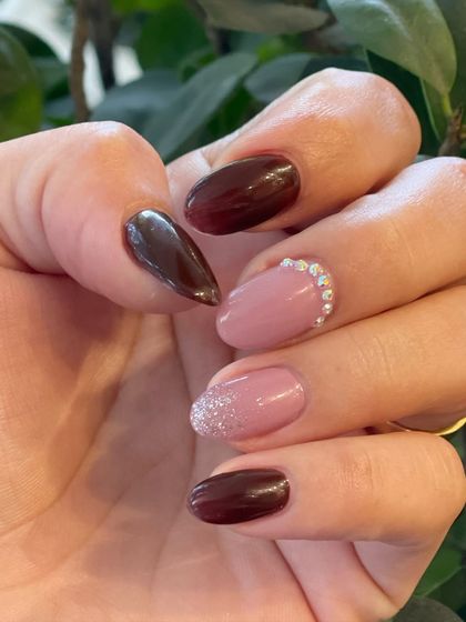 Our talented nail technicians can create any style you desire. This look combines solid colors with glitter and crystal accents for a touch of glamour.