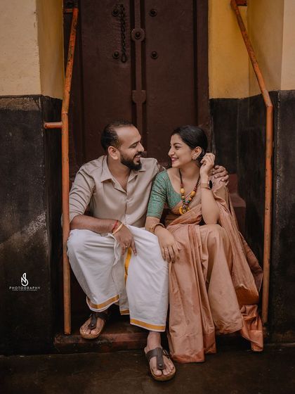 A happy, interactive pose on the steps. Their smiles and body language show a comfortable and loving relationship.