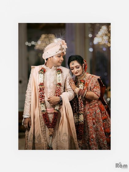A tender and classic portrait of the newly married couple, their beautiful red and cream outfits complementing each other perfectly.