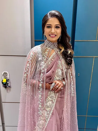 The full view of this captivating purple look, complete with a stunning cape saree.