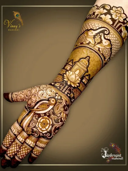 A single-hand view of the groom's sister's mehndi, showing the beautiful combination of a parrot, elephant, and dome motifs.