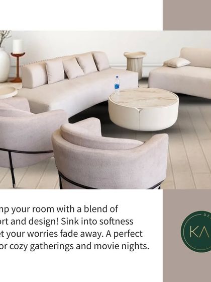 This expansive living room setup was designed for comfort and social gatherings. It features multiple seating elements, including curved sofas and armchairs in a soft, neutral palette, all arranged around a modern marble coffee table.