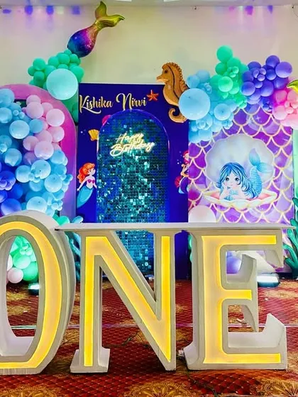A full stage view of the mermaid first birthday party, capturing the vibrant colors and all the decorative elements.