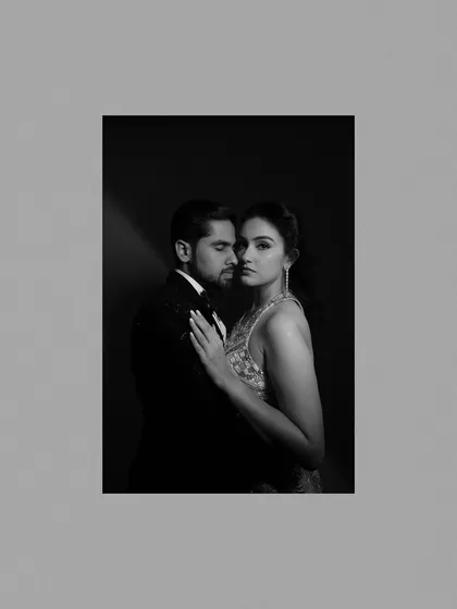 A striking black and white studio-style portrait of the couple, exuding glamour and sophistication.