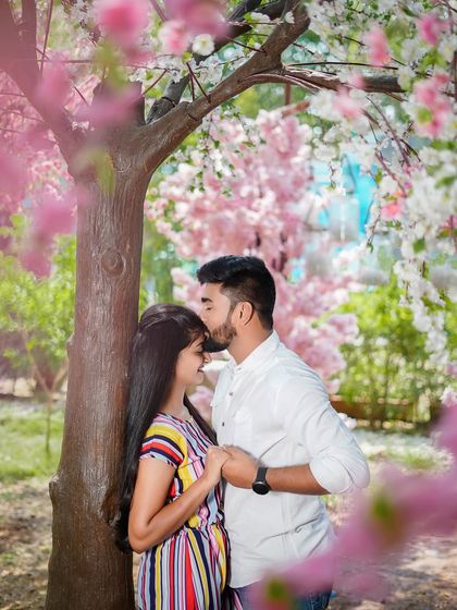 A gentle forehead kiss under the cherry blossoms. This is a timeless romantic pose that always results in a beautiful and emotional photograph.