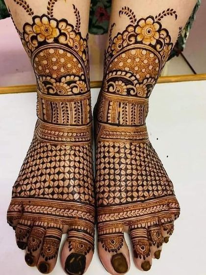 A detailed foot design with a dense checkerboard pattern on the top of the feet, complemented by floral bands around the ankles.