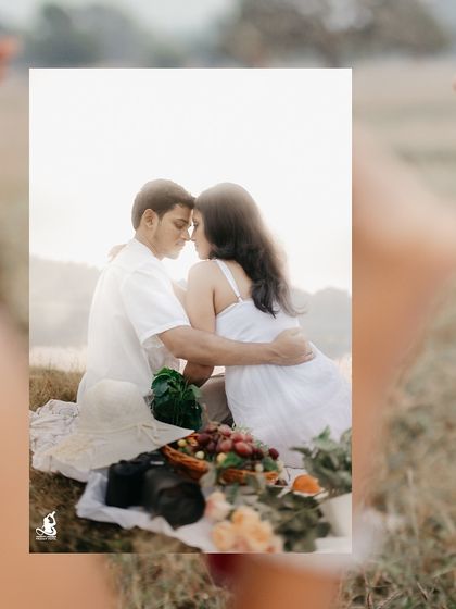 An intimate close-up of a couple during their lakeside picnic, surrounded by the soft light of sunset.